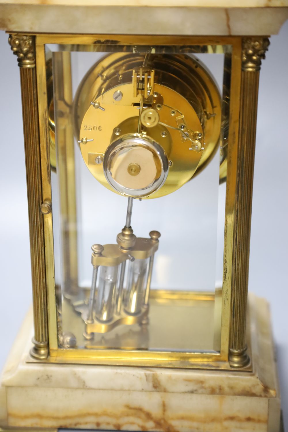An early 20th century French brass and onyx four glass clock